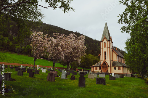 beautiful church in Kyrkjebø with its graveyard in the middle of Norwegian nature