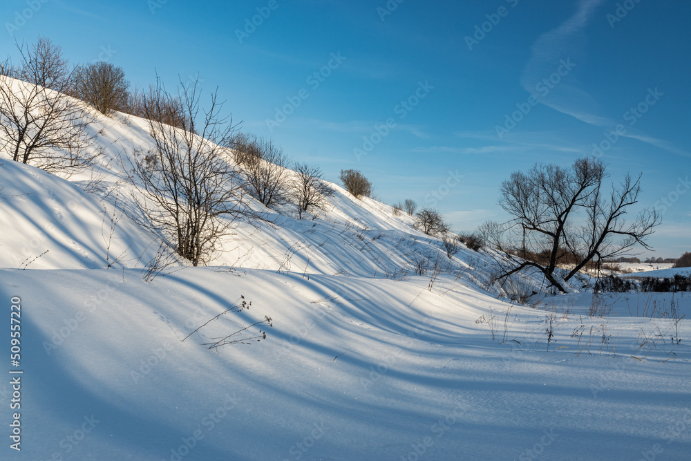 Fototapeta premium Winter nature landscape. Snowy slopes sunlight. Photo for decoration and design