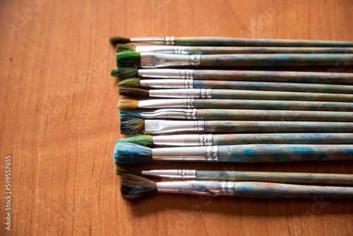 schoolchild's brushes for drawing are stacked in a row on the table and ready for the lesson, a blank for the designer