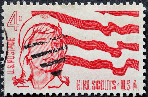 UNITED STATES - CIRCA 1962: a postage stamp from UNITED STATES , showing a portrait of a Senior Girl Scout and Flag. Circa 1962
