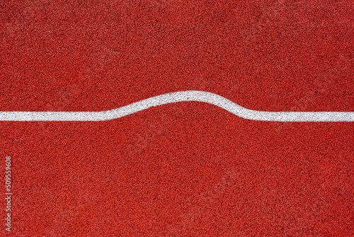 A white curved line drawn on a sports track