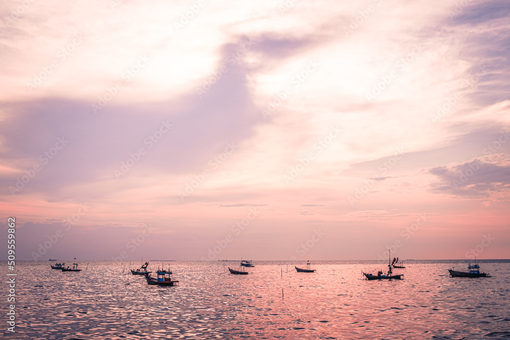 Beautiful sunrise on sea background with tropical wooden fishing boat pink tone Beautiful sunrise on sea background with tropical wooden fishing boat pink tone