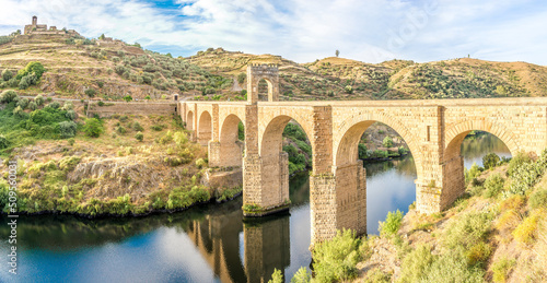 Panoramic view at the ancient Roman bridge over Tajo river in Alcantara, Spain photo