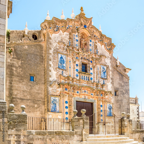 View at the fascade of Church of Saint Bartholomeus in the streets of Jerez de los Caballeros - Spain photo