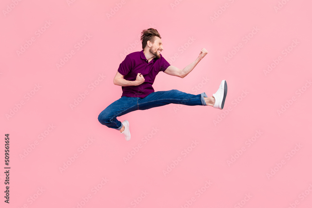 Full size profile side photo of young man jump rejoice luck fists hands isolated over pink color background