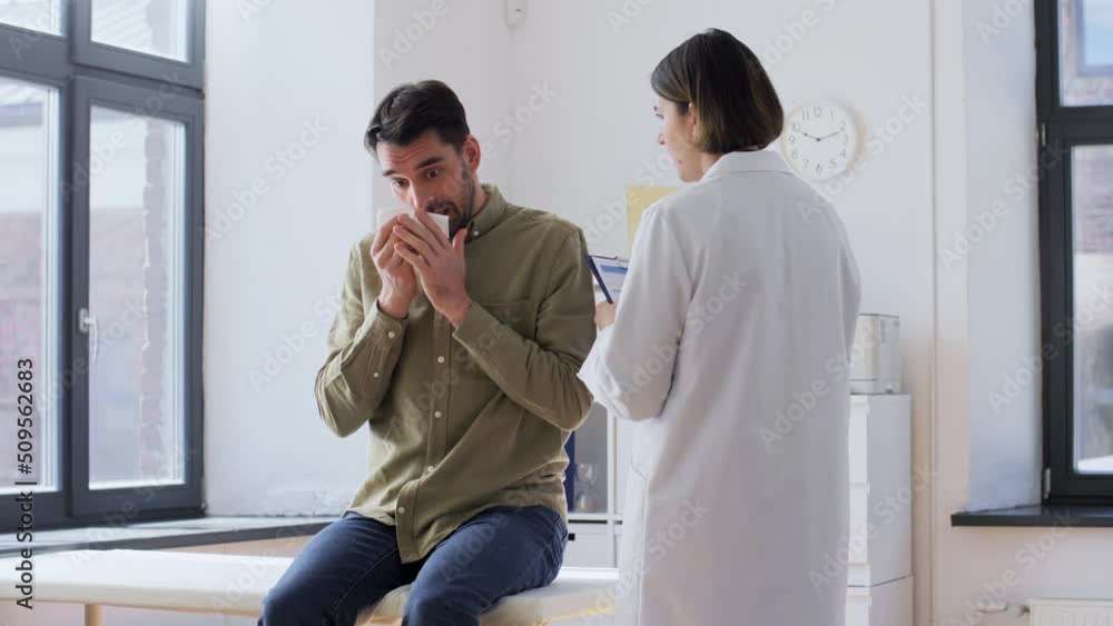 medicine, healthcare and people concept - female doctor with clipboard and sick male patient with paper tissue talking at hospital medicine, healthcare and people concept - female doctor with clipboard and sick male patient with paper tissue talking at hospital