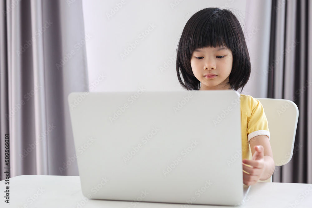 little asian girl student study online using laptop computer at home little asian girl student study online using laptop computer at home