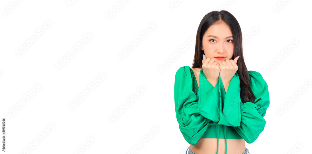 Attractive beautiful positive happy smile asian woman hands point up and pose with empty space wearing green shirt and jeans. Attractive beautiful positive happy smile asian woman hands point up and pose with empty space wearing green shirt and jeans.