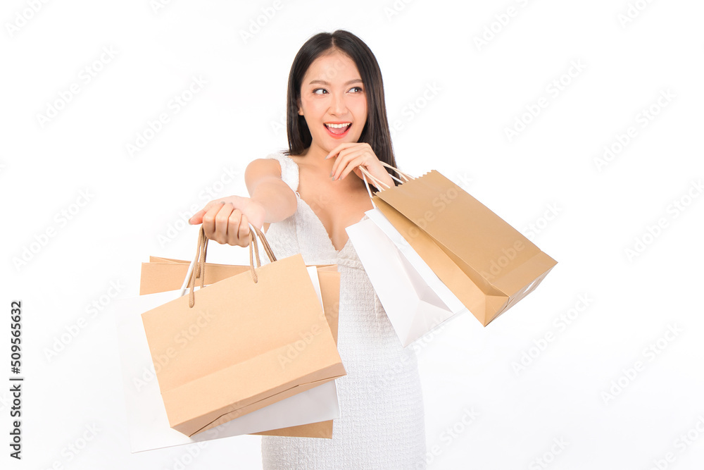 Portrait of young beautiful sexy asian female happy wearing a white dress holding shopping bags on white background. Portrait of young beautiful sexy asian female happy wearing a white dress holding shopping bags on white background.