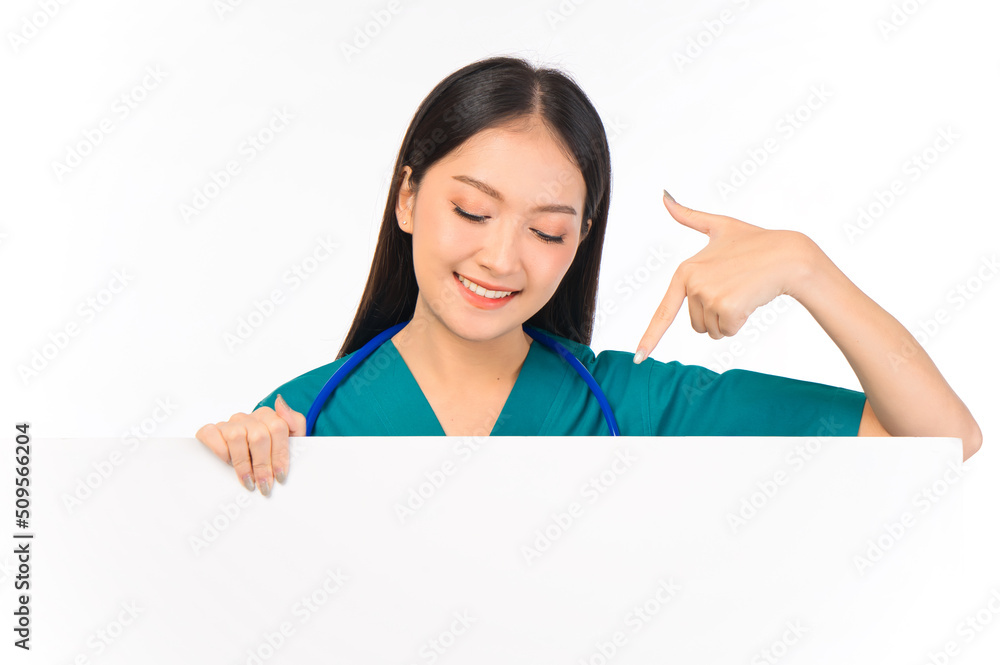 Portrait of professional confident young asian female smiling doctor in green scrubs showing presenting finger to paper billboard, doctor healthcare and doctors concept. Portrait of professional confident young asian female smiling doctor in green scrubs showing presenting finger to paper billboard, doctor healthcare and doctors concept.