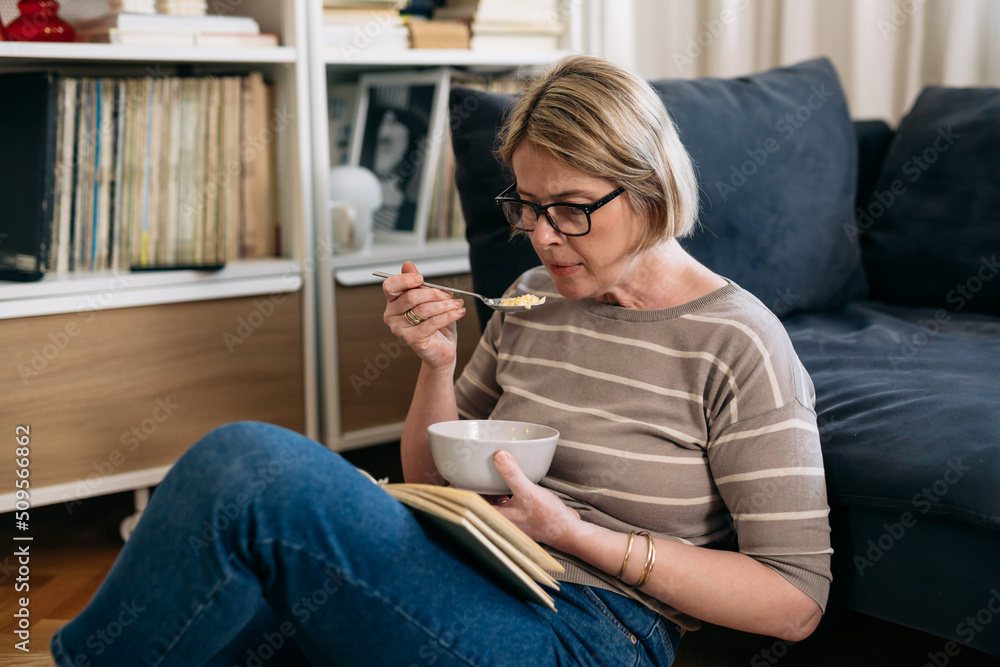 woman relaxing at home. reading book and having breakfast . woman relaxing at home. reading book and having breakfast .