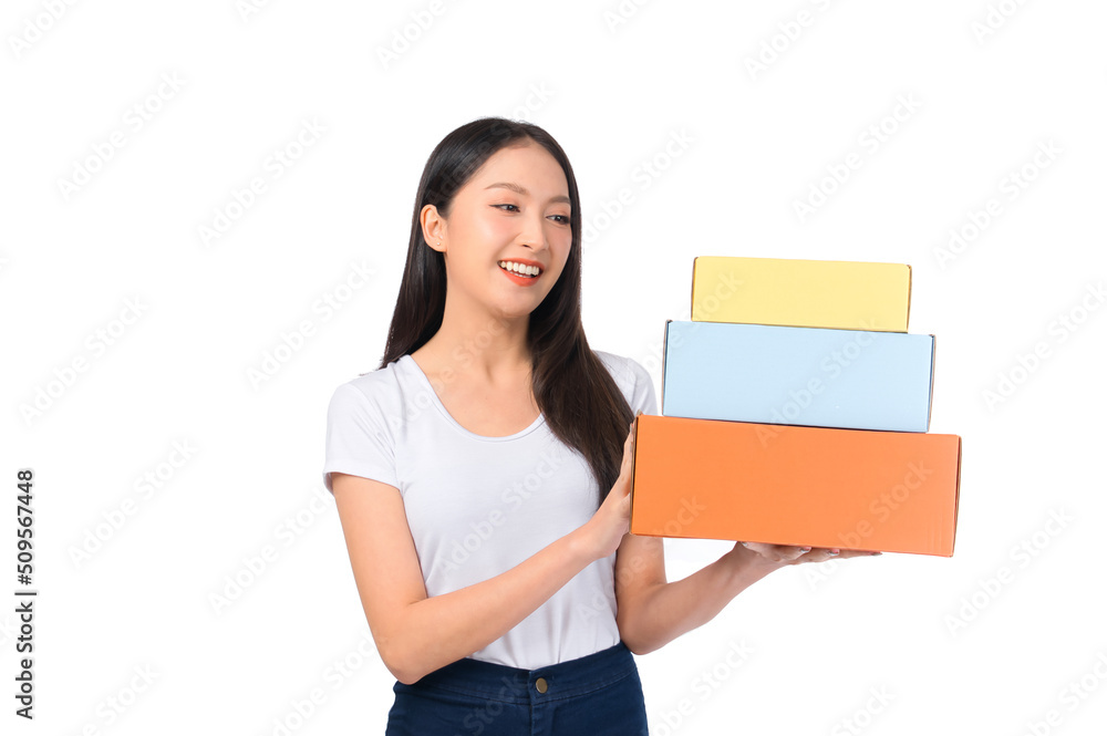 Happy cute asian woman smiling and holding package online marketing and delivery Start a small business at home on white background, Delivery shipping service concept.