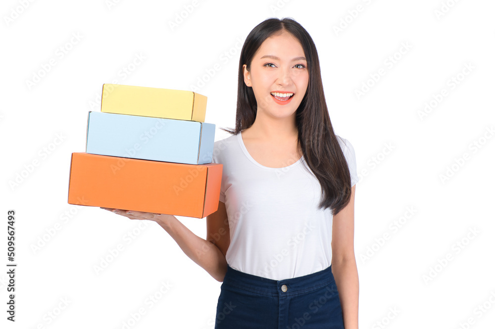 Happy cute asian woman smiling and holding package online marketing and delivery Start a small business at home on white background, Delivery shipping service concept. Happy cute asian woman smiling and holding package online marketing and delivery Start a small business at home on white background, Delivery shipping service concept.