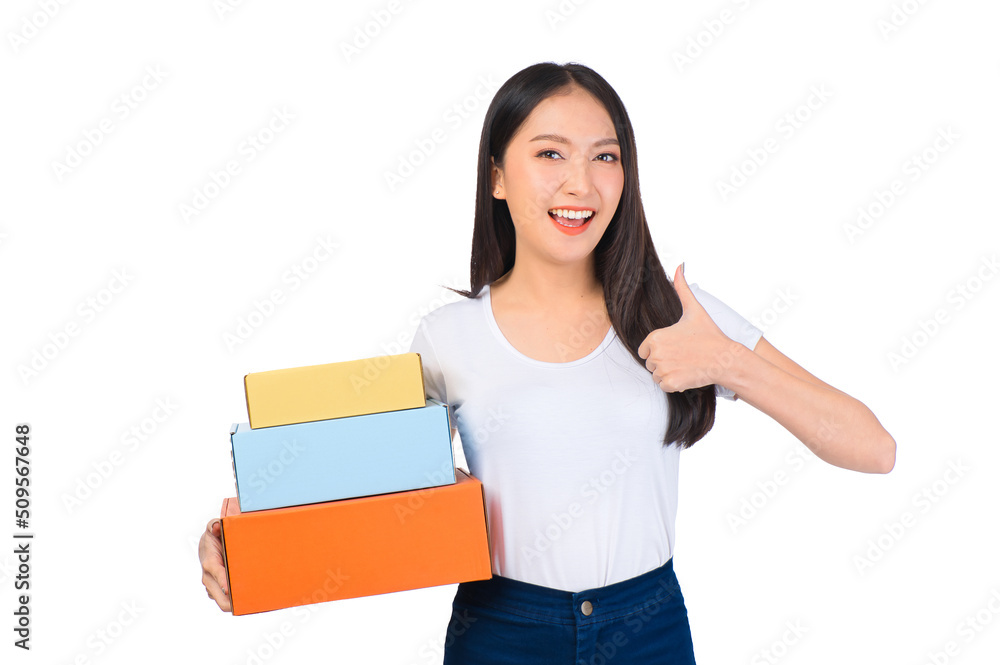 Happy cute asian woman smiling and holding package online marketing and delivery Start a small business at home on white background, Delivery shipping service concept.