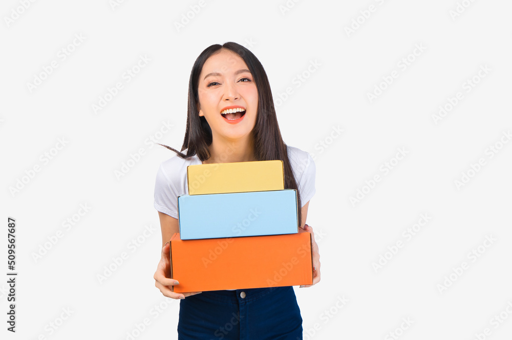 Happy cute asian woman smiling and holding package online marketing and delivery Start a small business at home on white background, Delivery shipping service concept. Happy cute asian woman smiling and holding package online marketing and delivery Start a small business at home on white background, Delivery shipping service concept.
