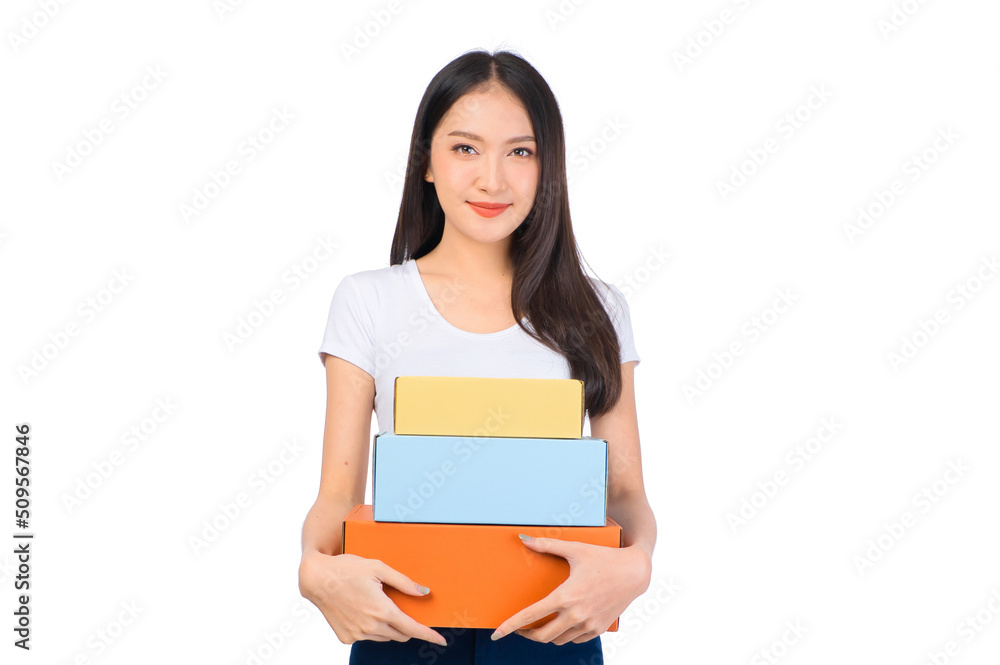 Happy cute asian woman smiling and holding package online marketing and delivery Start a small business at home on white background, Delivery shipping service concept. Happy cute asian woman smiling and holding package online marketing and delivery Start a small business at home on white background, Delivery shipping service concept.