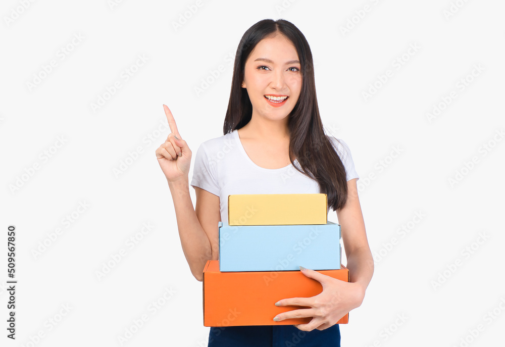 Happy cute asian woman smiling and holding package online marketing and delivery Start a small business at home on white background, Delivery shipping service concept. Happy cute asian woman smiling and holding package online marketing and delivery Start a small business at home on white background, Delivery shipping service concept.