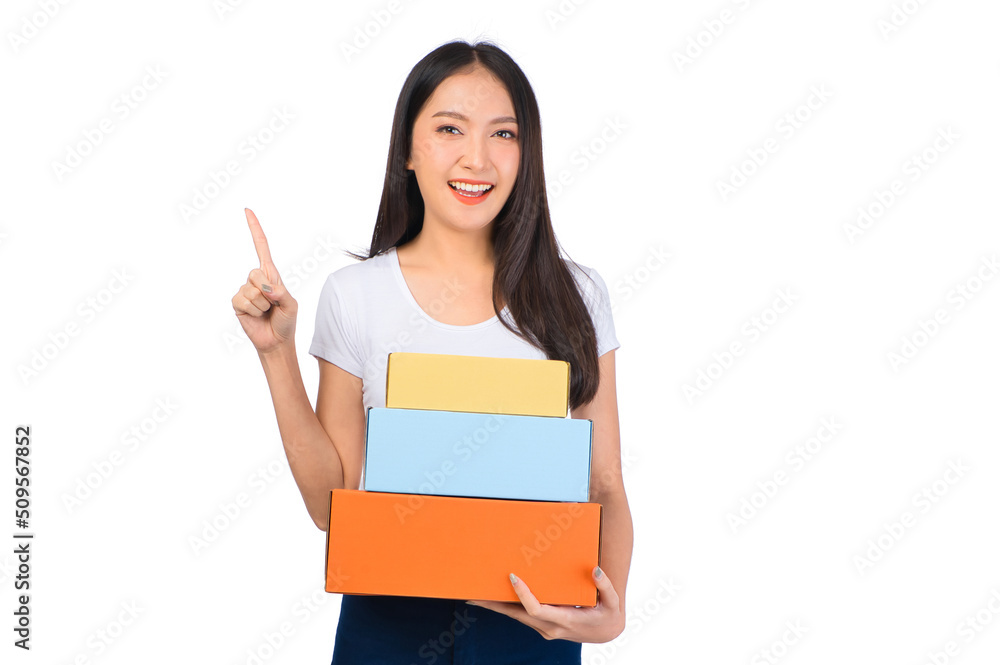 Happy cute asian woman smiling and holding package online marketing and delivery Start a small business at home on white background, Delivery shipping service concept. Happy cute asian woman smiling and holding package online marketing and delivery Start a small business at home on white background, Delivery shipping service concept.