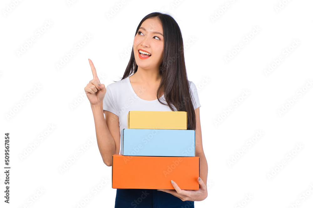 Happy cute asian woman smiling and holding package online marketing and delivery Start a small business at home on white background, Delivery shipping service concept. Happy cute asian woman smiling and holding package online marketing and delivery Start a small business at home on white background, Delivery shipping service concept.