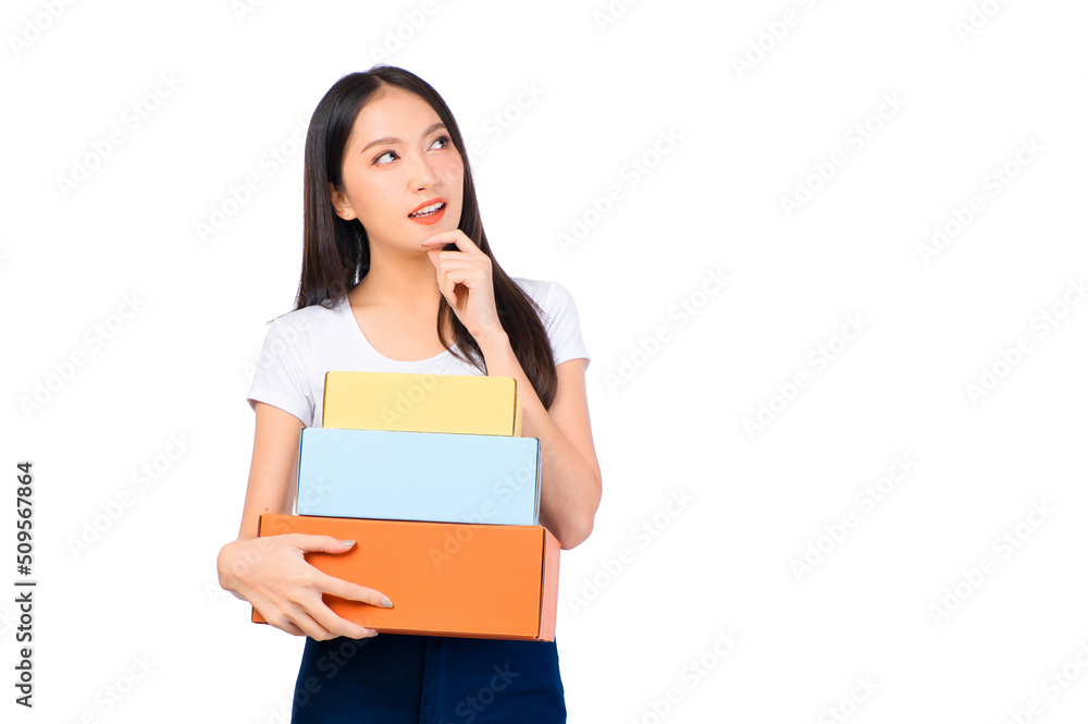 Happy cute asian woman smiling and holding package online marketing and delivery Start a small business at home on white background, Delivery shipping service concept. Happy cute asian woman smiling and holding package online marketing and delivery Start a small business at home on white background, Delivery shipping service concept.