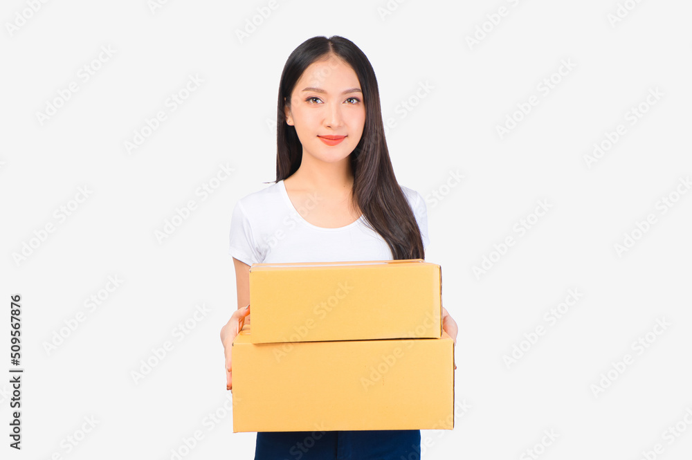 Happy cute asian woman smiling and holding package online marketing and delivery Start a small business at home on white background, Delivery shipping service concept. Happy cute asian woman smiling and holding package online marketing and delivery Start a small business at home on white background, Delivery shipping service concept.