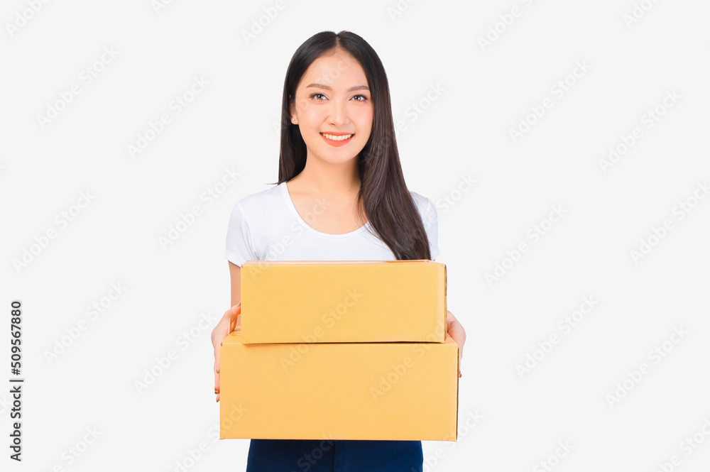 Happy cute asian woman smiling and holding package online marketing and delivery Start a small business at home on white background, Delivery shipping service concept. Happy cute asian woman smiling and holding package online marketing and delivery Start a small business at home on white background, Delivery shipping service concept.