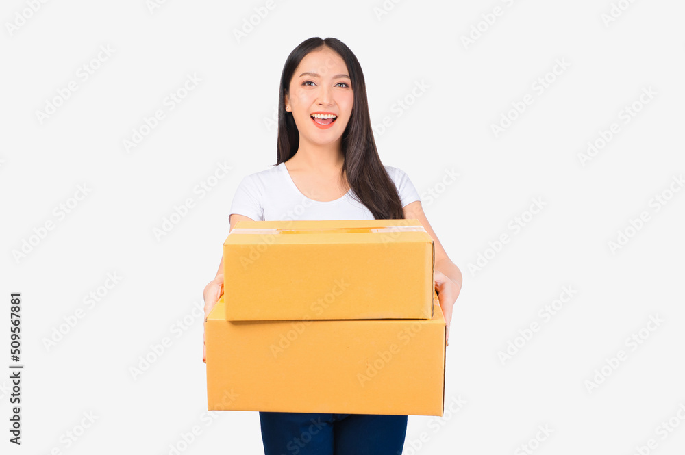 Happy cute asian woman smiling and holding package online marketing and delivery Start a small business at home on white background, Delivery shipping service concept. Happy cute asian woman smiling and holding package online marketing and delivery Start a small business at home on white background, Delivery shipping service concept.