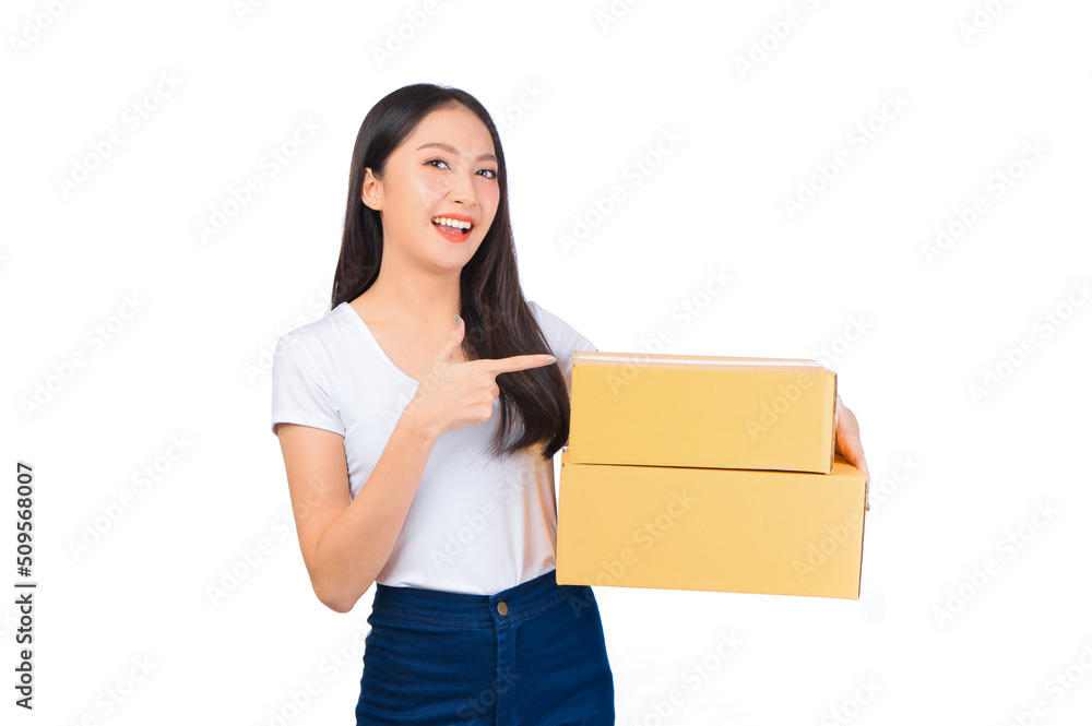 Happy cute asian woman smiling and holding package online marketing and delivery Start a small business at home on white background, Delivery shipping service concept. Happy cute asian woman smiling and holding package online marketing and delivery Start a small business at home on white background, Delivery shipping service concept.