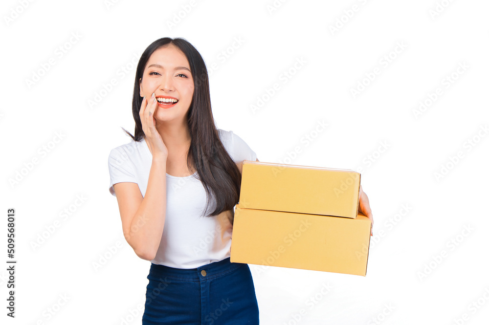 Happy cute asian woman smiling and holding package online marketing and delivery Start a small business at home on white background, Delivery shipping service concept. Happy cute asian woman smiling and holding package online marketing and delivery Start a small business at home on white background, Delivery shipping service concept.