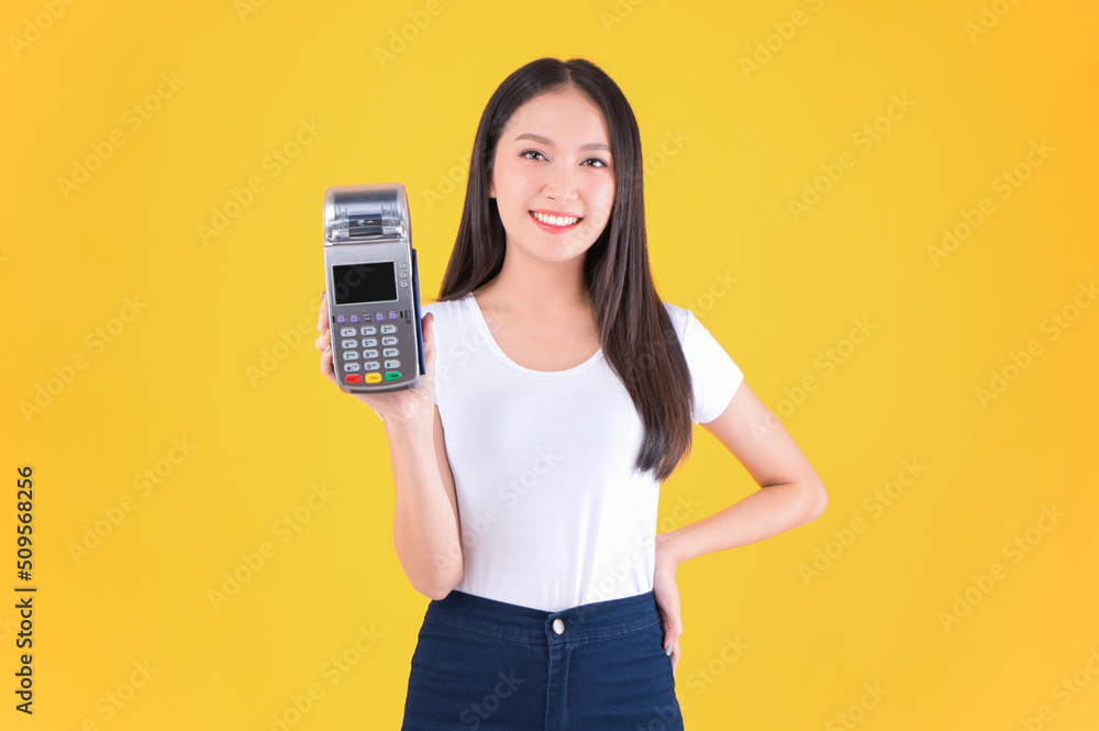 Moment of payment, payment with a credit card through terminal money yellow background,Mobile banking, online shopping Payment by card with the payment terminal. Moment of payment, payment with a credit card through terminal money yellow background,Mobile banking, online shopping Payment by card with the payment terminal.