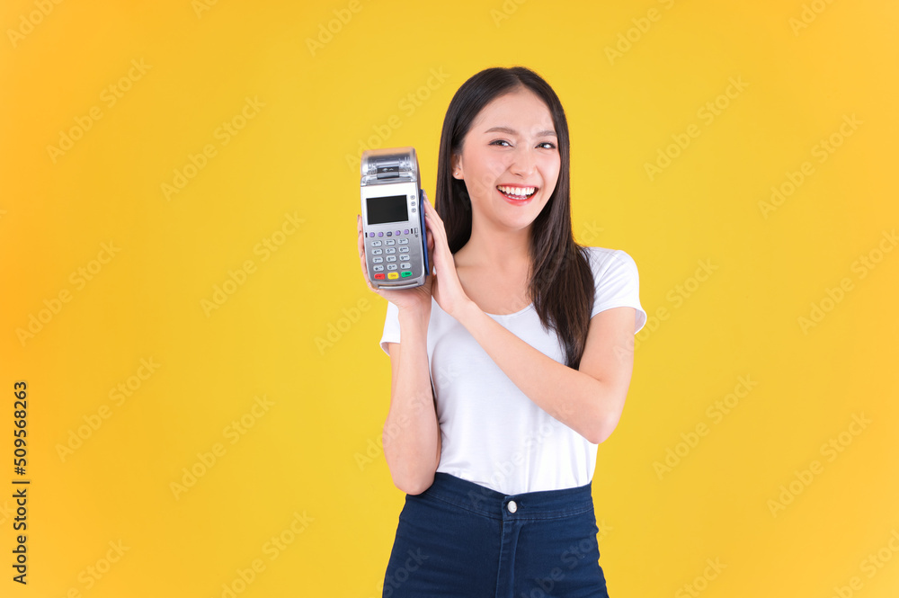 Moment of payment, payment with a credit card through terminal money yellow background,Mobile banking, online shopping Payment by card with the payment terminal. Moment of payment, payment with a credit card through terminal money yellow background,Mobile banking, online shopping Payment by card with the payment terminal.