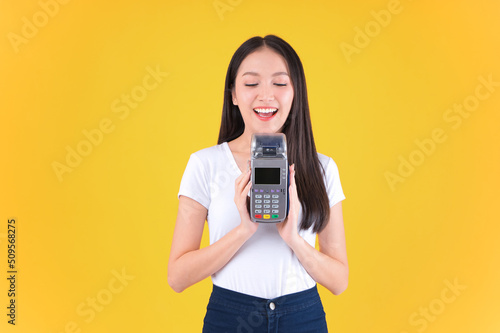 Moment of payment, payment with a credit card through terminal money yellow background,Mobile banking, online shopping money and financial concepts.