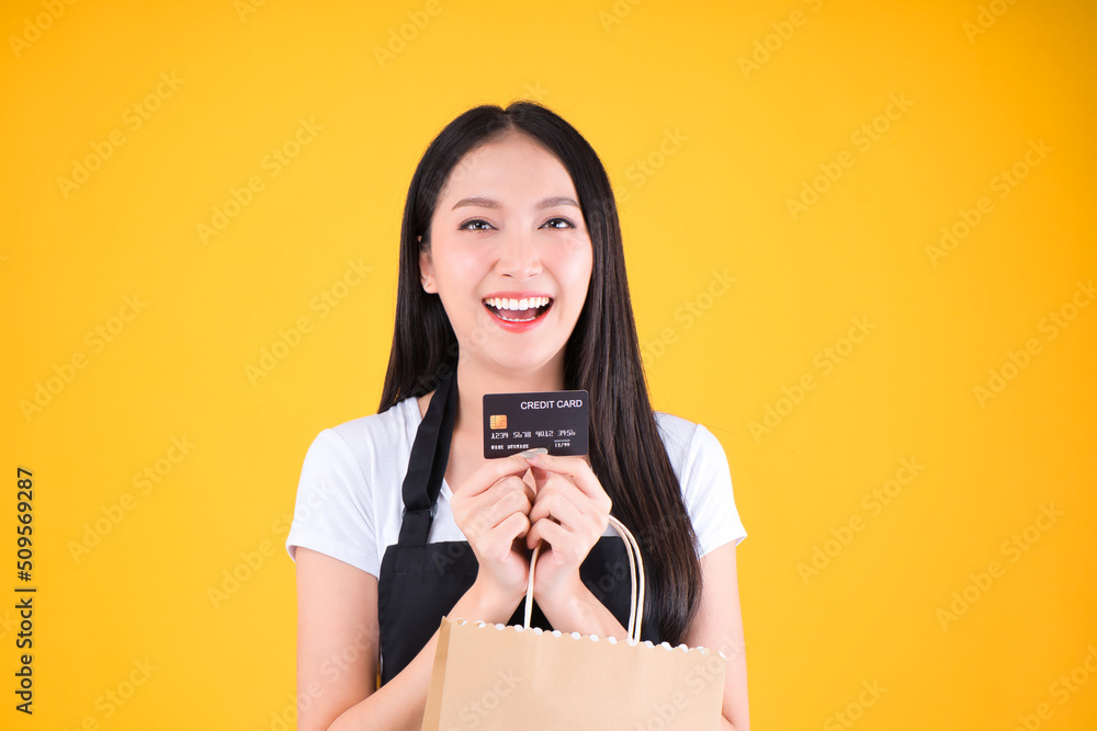 © Png - Video - Photo - asian female smile wearing black apron holding paper bag and payment with a credit card through terminal money swiping a credit card © Png - Video - Photo - asian female smile wearing black apron holding paper bag and payment with a credit card through terminal money swiping a credit card