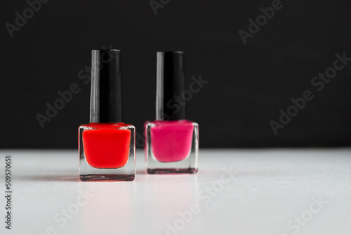 Red and pink nail polish on the black and white background