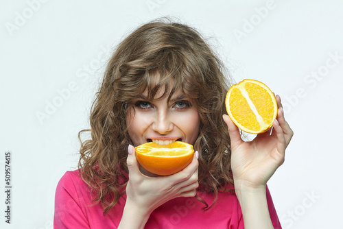 attractive girl with oranges in her hands photo shoot in the studio on a white background