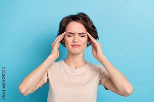 Portrait of young adorable lady suffering strong migraine touch forehead temples isolated on blue color background