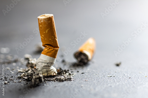 Fotografija Cigarette butt on floor, environmental pollution, cigarette yellow filters