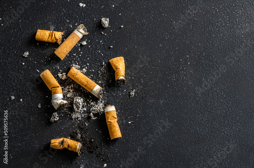 Cigarette butt on floor, environmental pollution, cigarette yellow filters