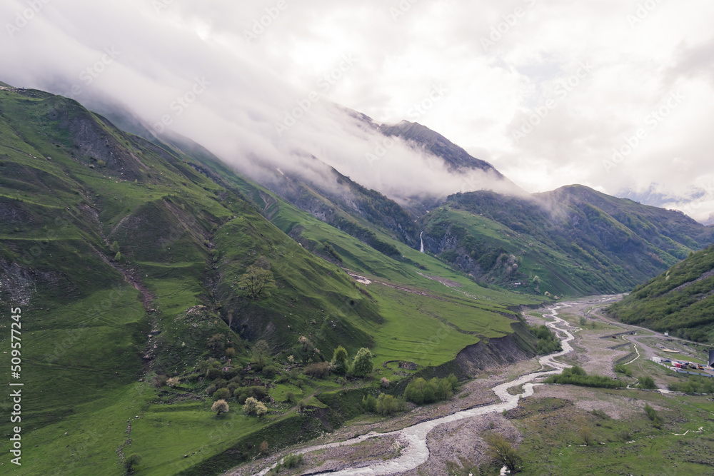 Fototapeta premium birds-eye view of old Military Road between Georgia and Russia in Dariali gorge, river Tergi, Georgia. High quality photo