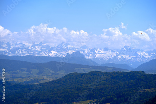 Aerial view of landscape at Canton Z  rich with the Swiss Alps in the background seen from local mountain Uetliberg on a sunny spring day. Photo taken May 18th  2022  Zurich  Switzerland.