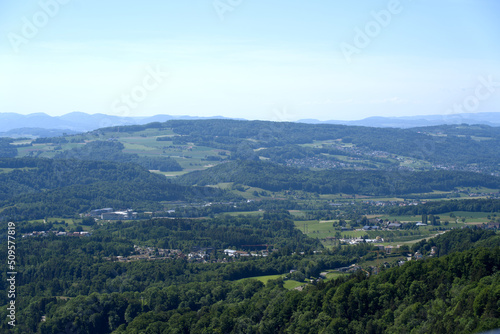 Aerial view of midland with agricultural fields, wood and hills seen from local mountain Uetliberg on a sunny spring day. Photo taken May 18th, 2022, Zurich, Switzerland.