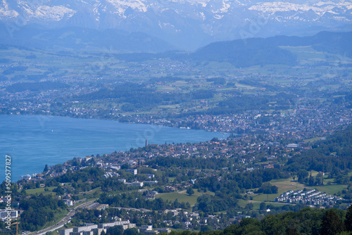 Aerial view of Lake Zürich and Canton Zürich with the Swiss Alps in the background seen from local mountain Uetliberg on a sunny spring day. Photo taken May 18th, 2022, Zurich, Switzerland. © Michael Derrer Fuchs