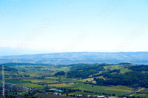 Aerial view of midland with agricultural fields  wood and hills seen from local mountain Uetliberg on a sunny spring day. Photo taken May 18th  2022  Zurich  Switzerland.