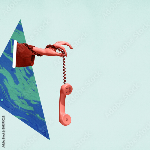 Fotografie Colorful bright image of female hand holding old-fashioned pink colored phone, handset isolated over light background