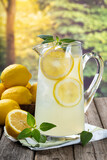 Pitcher of lemonade with summer background
