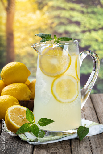 Pitcher of lemonade with summer background