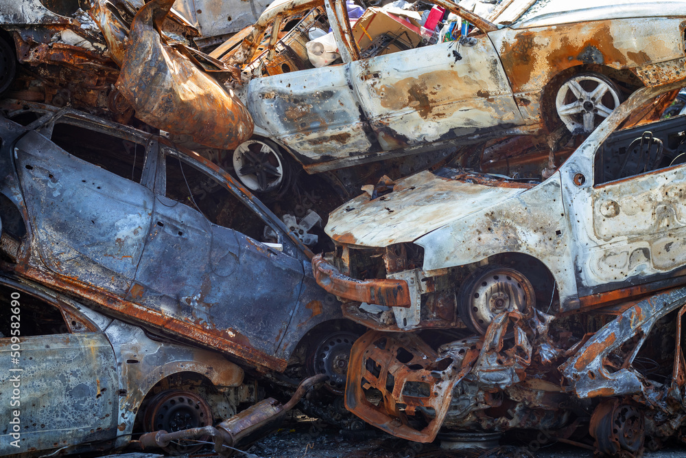 Russian invasion of Ukraine in 2022, destroyed and burned cars. Cars were beaten with shrapnel and burned. Irpensky automobile cemetery. The consequences of the war in a peaceful city near Kyiv.