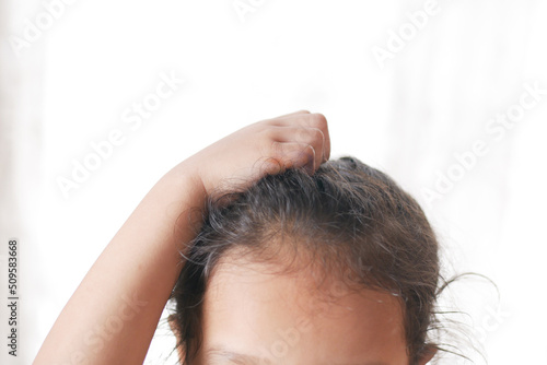  child Scratching Head Against white background .