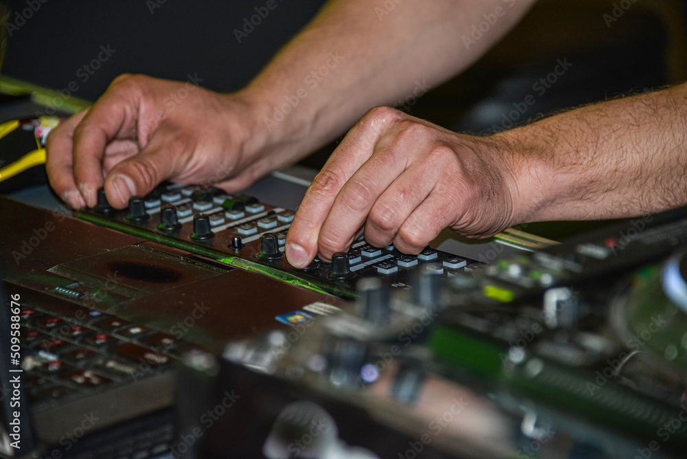 Fingers on the buttons of the DJ console Fingers on the buttons of the DJ console