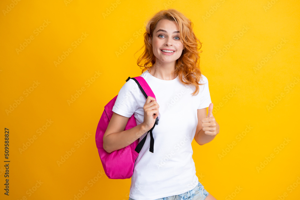 Surprised fun teen student girl with backpack on pastel yellow color background. Education in university college concept. Surprised fun teen student girl with backpack on pastel yellow color background. Education in university college concept.
